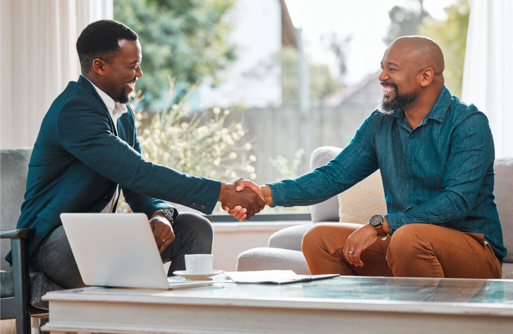 Two people shaking hands sitting