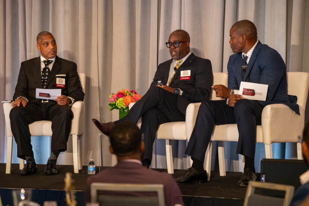 Four men leading a panel discussion at the AAAA 2024 Vision Conference